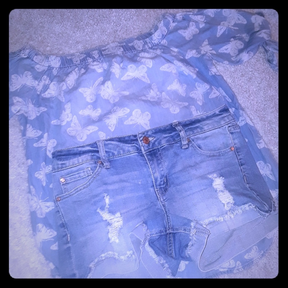 Off the shoulder butterfly shirt, ripped shorts.